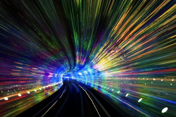 The road leading to a Colored tunnel with lights