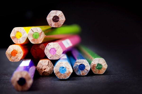 Colorful pencils are lying on the table