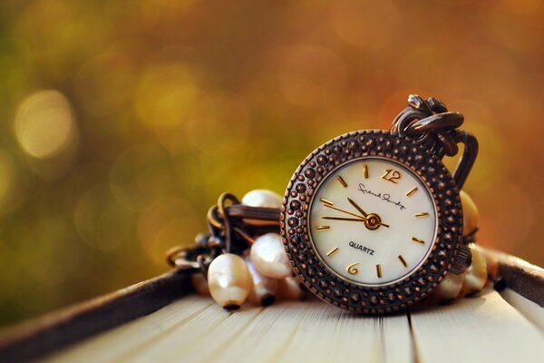 Pendant in the form of a clock on a blurry background