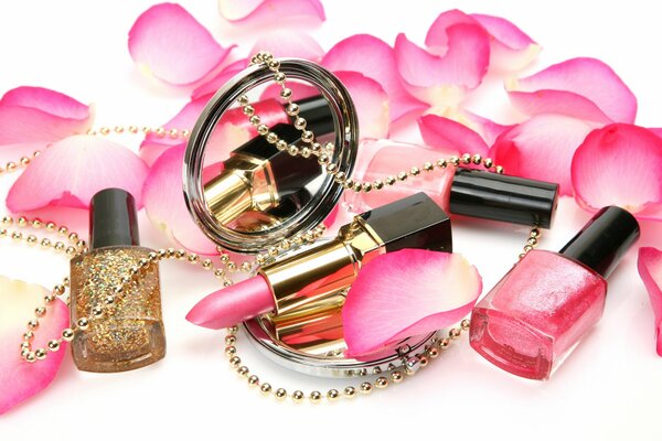 Cosmetics with pink petals on a white background