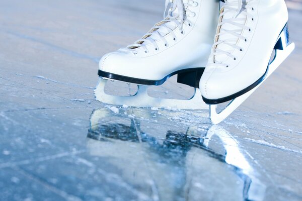 White skates on mirrored ice