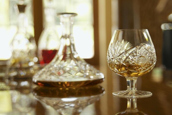 Crystal wine glass and decanter with whiskey