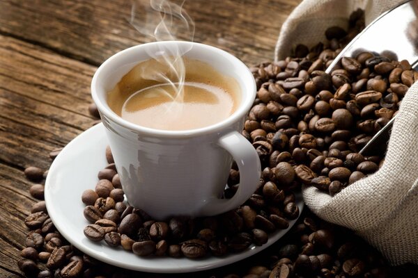 A bag of coffee beans, about a brewed espresso cup