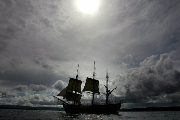 Sailboat on the horizon with clouds