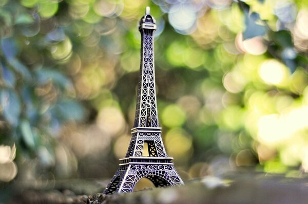 A statuette of the Eiffel Tower. Parisian greenery
