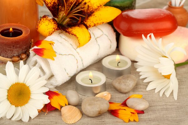 Spa floating candles, chamomile flowers, stones, towel, soap