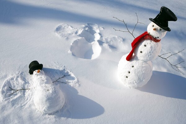 Two snowmen in black hats