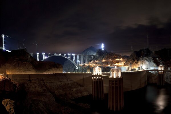 The big dam in America and the bridge illuminated by white light