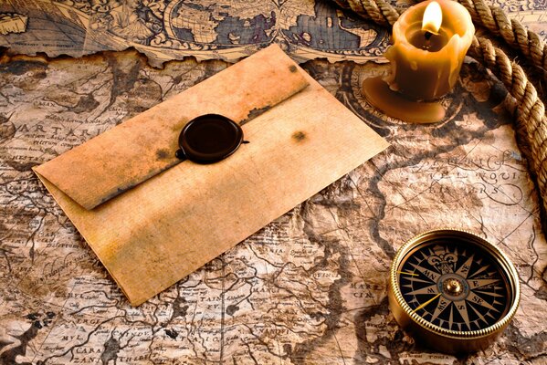 There is an envelope with a compass on the map