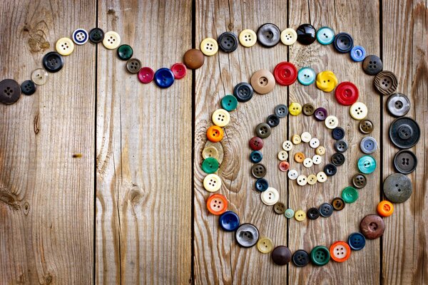 Buttons laid out in a spiral on the table