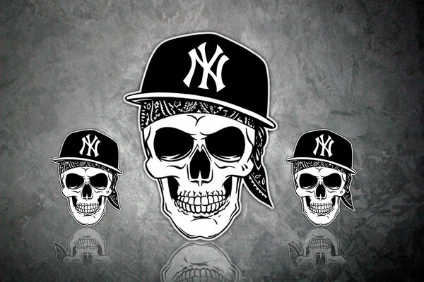 Three skulls in caps on a gray background