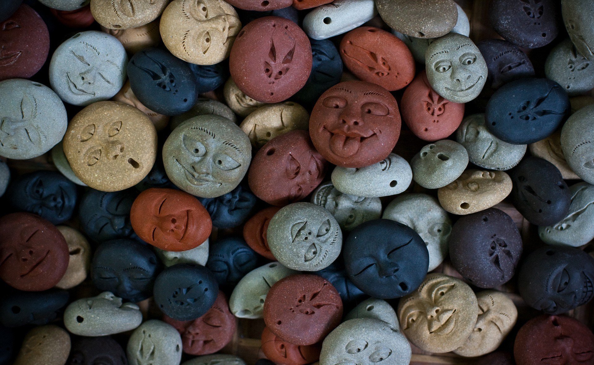 figures face faces stones blue grey brown red