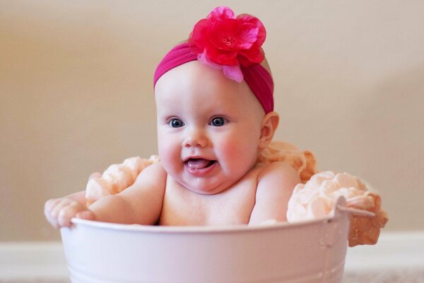 Charming baby in a bucket with sourdough