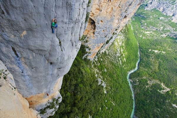 A man climbs up a cliff