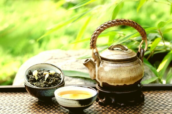 Brewed green tea in a clay teapot