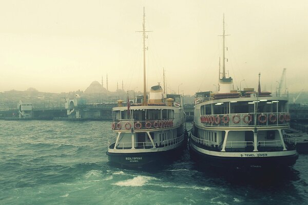 Boats on the background of a foggy haven