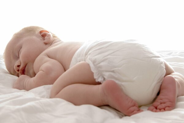 Photo of a baby sleeping on a bed