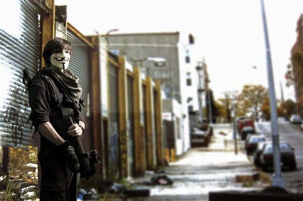 A masked man with a gun is standing on the street