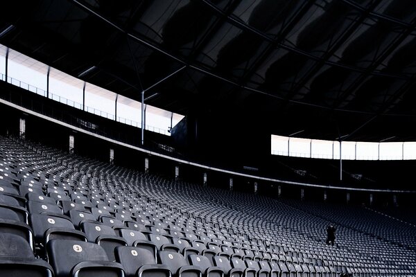 Photographer in an empty hall with seats