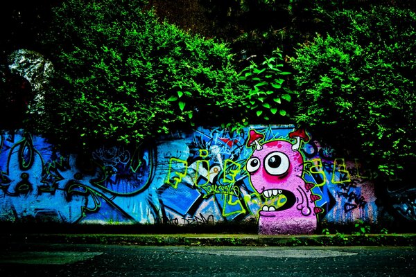 Graffiti on the wall. Monster with toadstools on his head