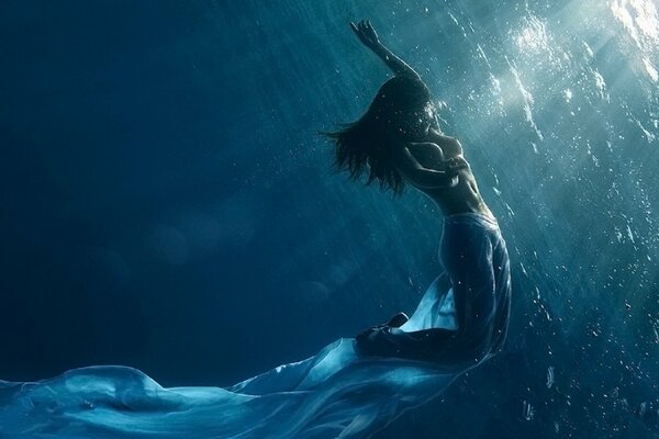 Girl in a long skirt underwater