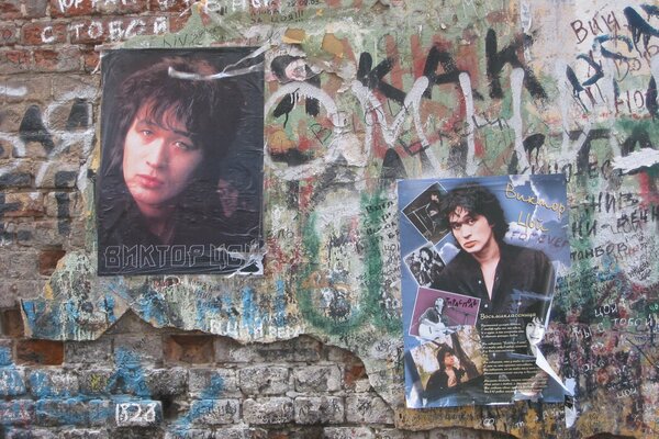 Brick wall with photos of Viktor Tsoi