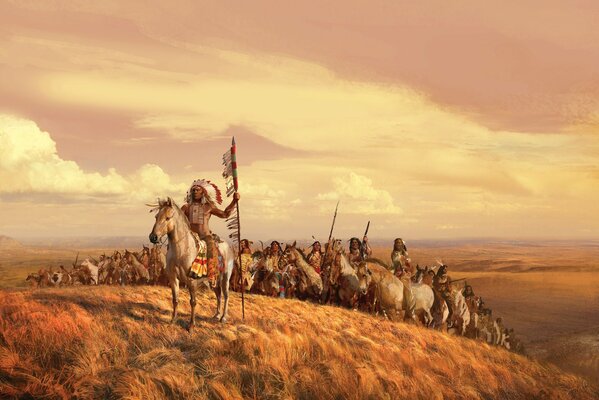 The leader of the Indians stands in front of them in a field on a horse