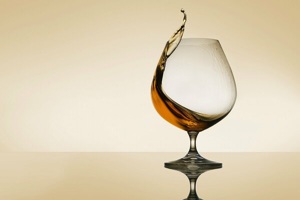 A glass of expensive cognac splash