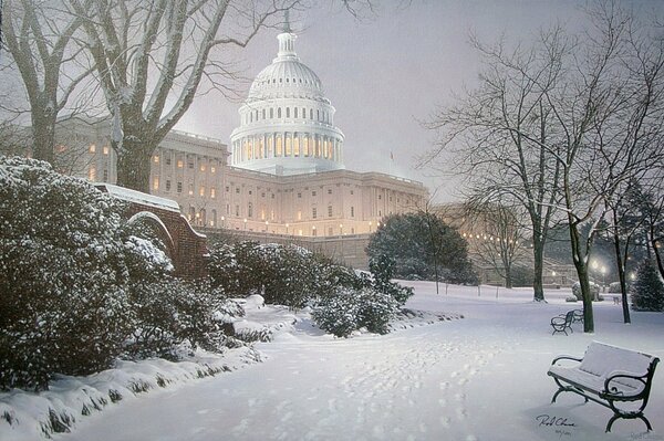 Snow-covered bench in the evening park