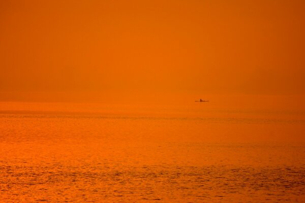 Sea sunset and longboat