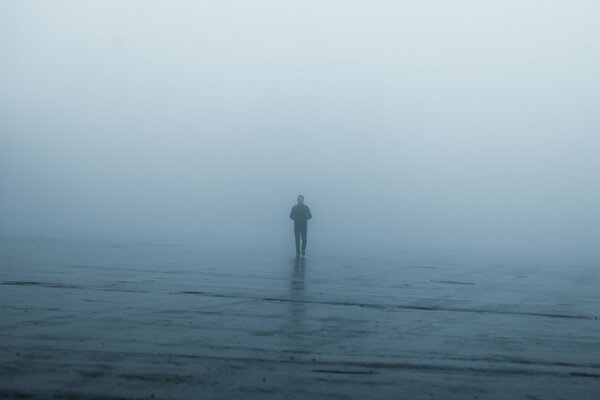 A lonely man in the fog during the rain