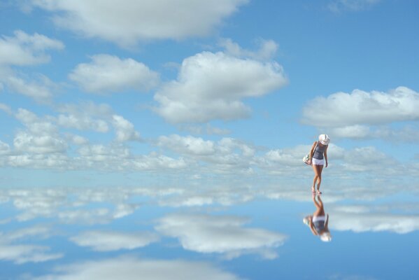 Riflessione della donna e del cielo nello specchio