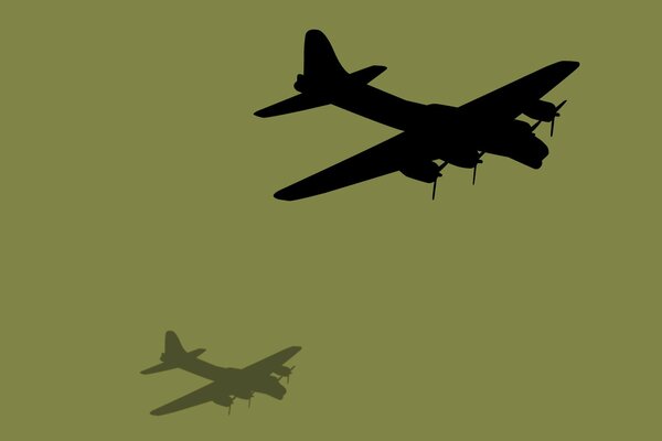 The shadow of a four-screw aircraft on a brown background