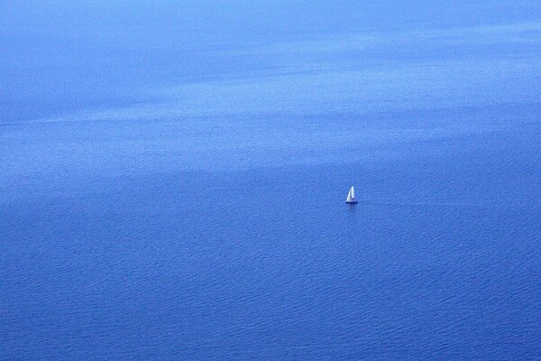 A lonely sailboat in the blue sea