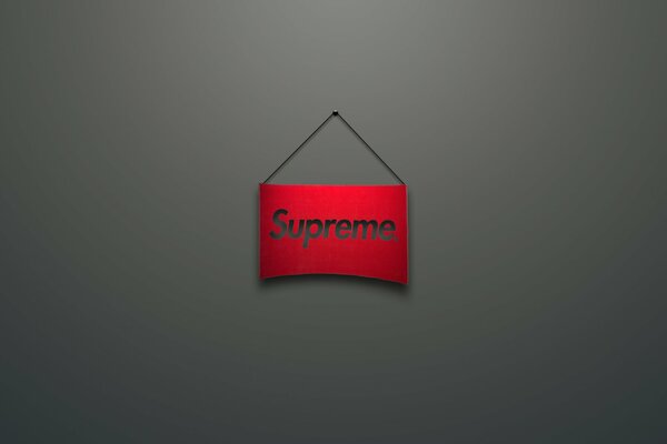 Logo Supreme. sur le panneau rouge. Fond gris