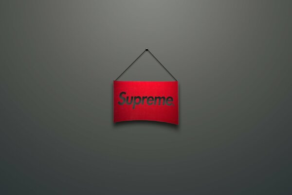 Логотип Supreme. на красной вывеске. Серый фон