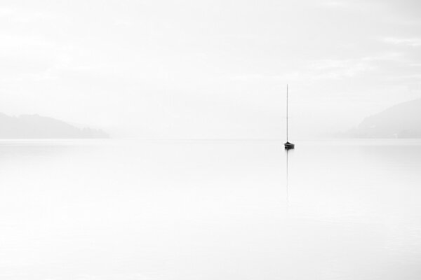 Minimalism a lonely boat in the fog