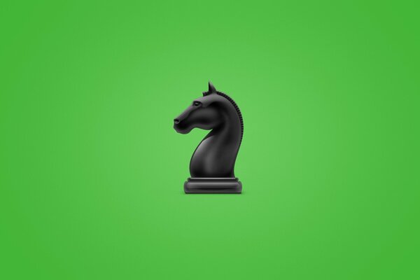 Figurine d échecs, cheval noir. Représenté sur fond vert