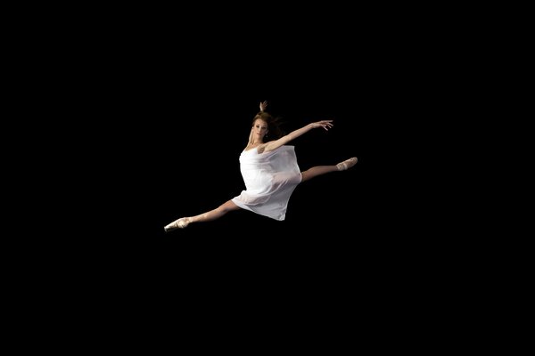 Gorgeous ballerina on a black background