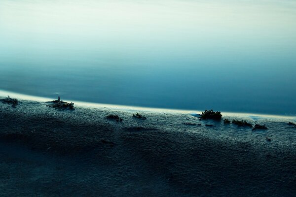 There is blue water on the seashore