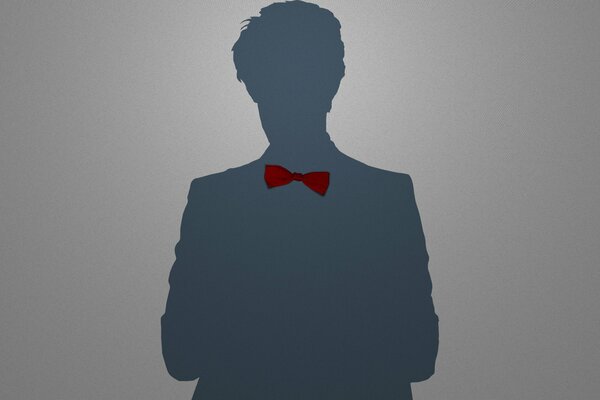 Silhouette of a man in a red bow tie