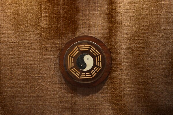Yin-yang symbol on a brown background