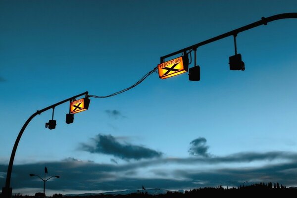 Signs on poles in the evening in the blue sky