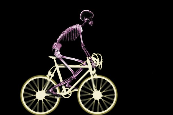 A skeleton on a bicycle in X-ray on a black background