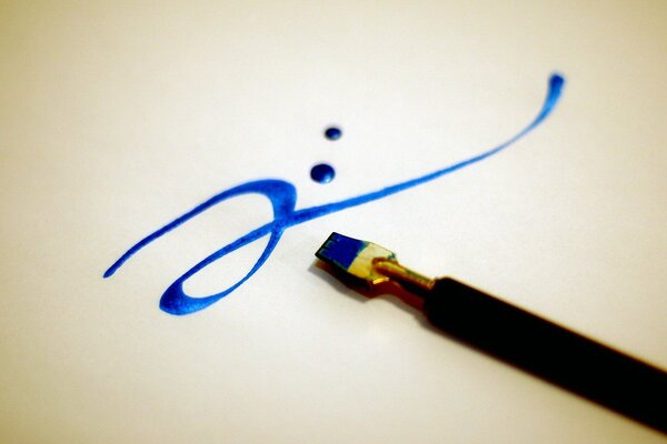 Calligraphy in blue with a brush on the surface