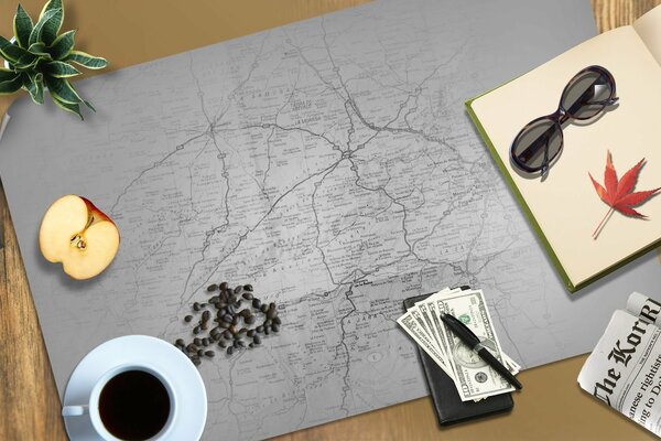 Choosing a travel route on the map over a cup of coffee