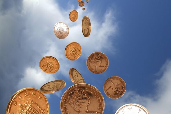 Money (coins) are pouring right out of the blue sky
