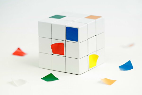 Cubo di Rubik con facce cadenti su sfondo bianco