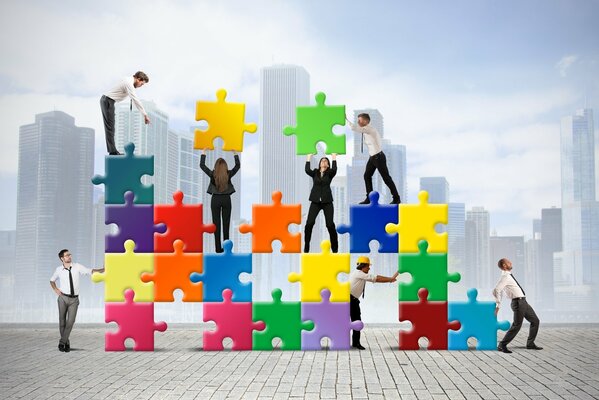 People building a multi-colored puzzle