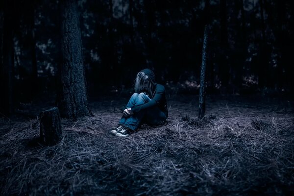 A girl in the night forest alone